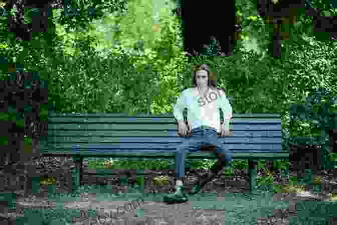 Ethan, A Young Man, Sitting On A Bench In A Park, Looking Thoughtful. Dear Freedom Writer: Stories Of Hardship And Hope From The Next Generation