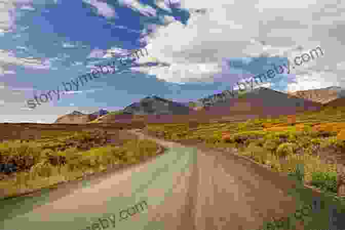 Panoramic View Of The Dempster Highway Winding Through A Mountain Pass Driving The Dempster: Northwest Territories Canada